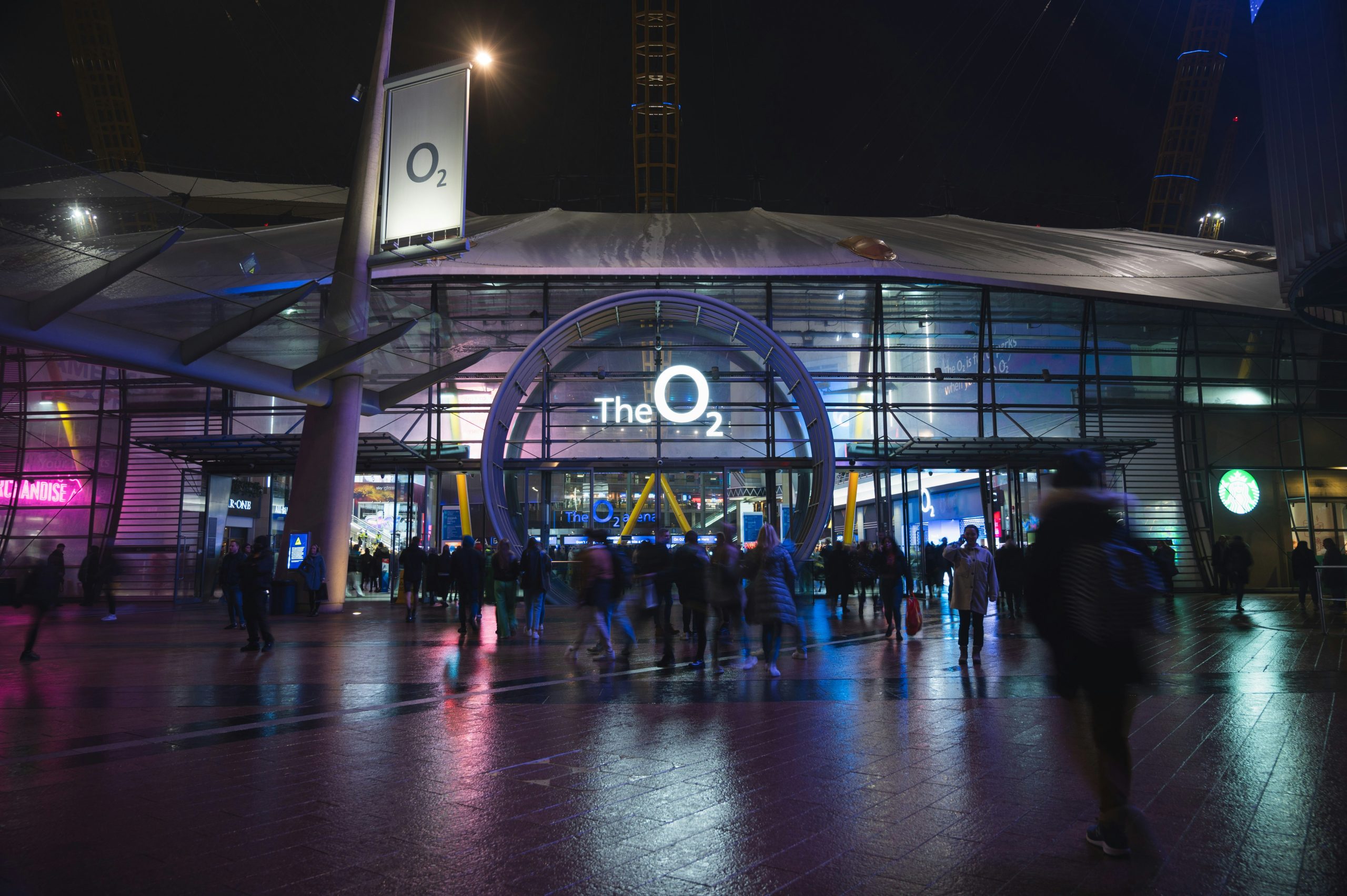 People walking in front of a building at night.