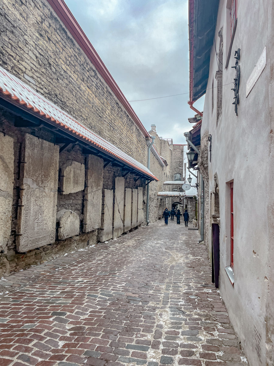 A cobblestone street surrounded by stone buildings and walls.