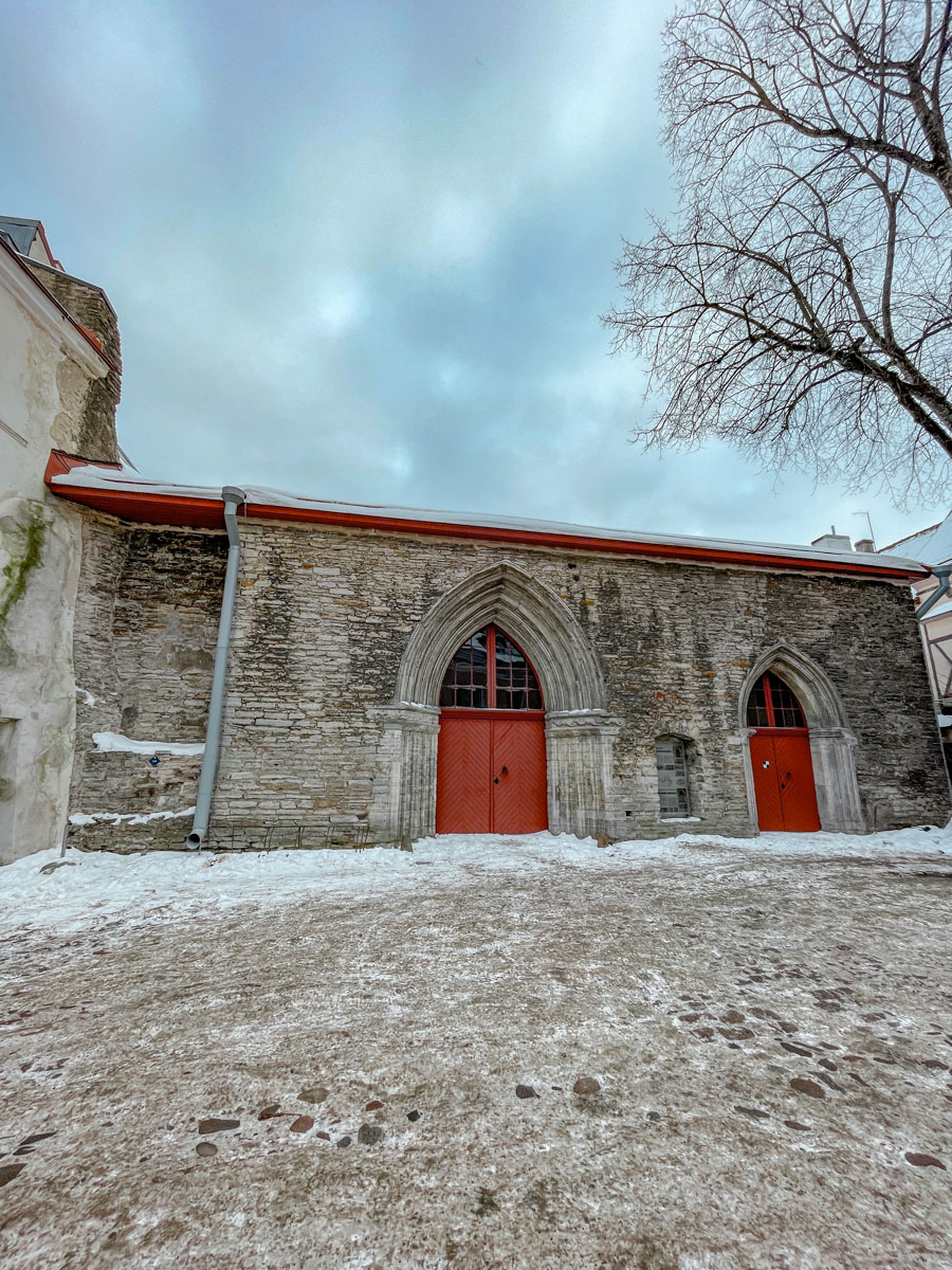 Small buildings made of stone walls and with red gates.