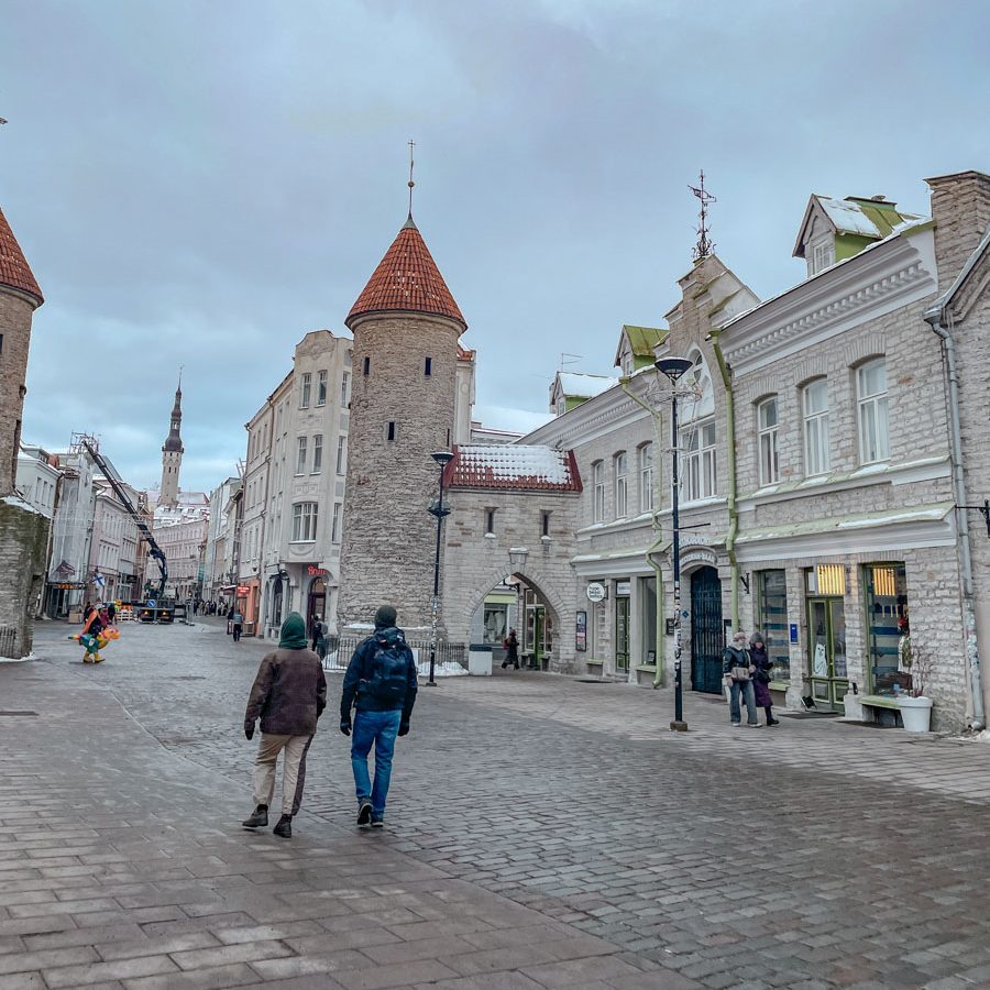 People walking on the cobblestone streets of Tallinn, Estonia.