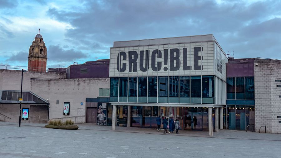 The outside of a theater building in Sheffield, England with "CRUCIBLE" text on the upper wall.