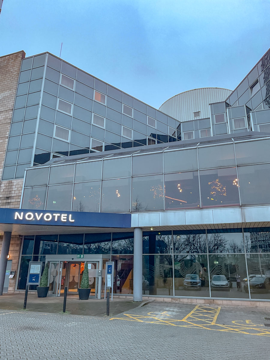The entrance of a hotel with sign that says "NOVOTEL" in Sheffield, UK.