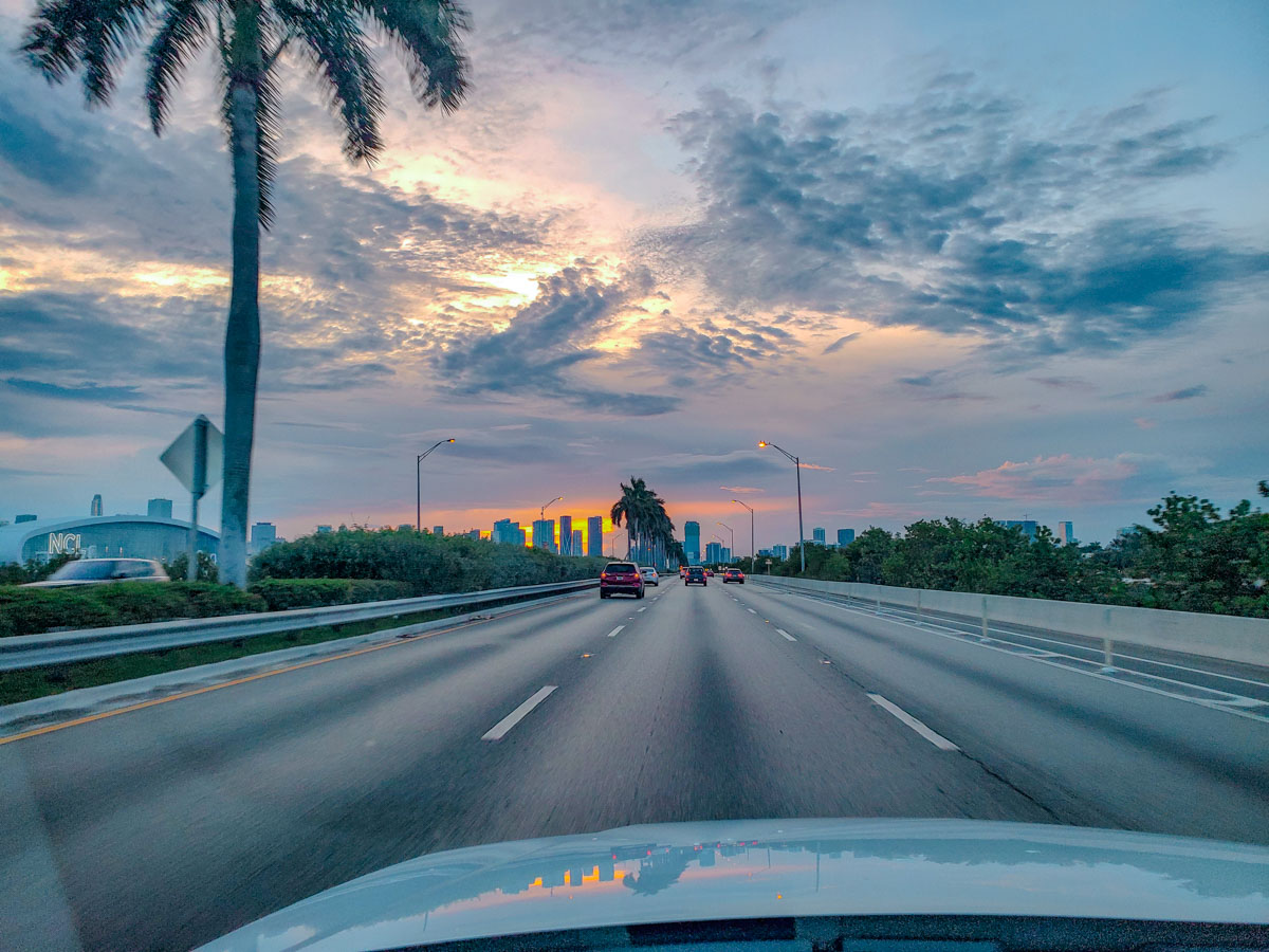 Cars on the road in Key West, Florida at sunset.