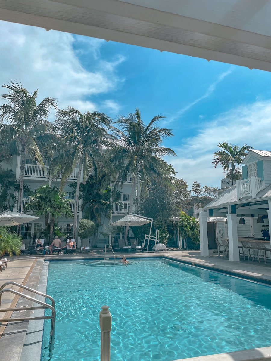 A swimming pool surrounded by palm trees at a resort in Key West, Florida.