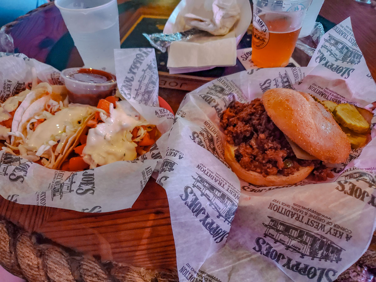 Sandwiches, salad, and beer on a table at a restaurant in Key West, Florida.