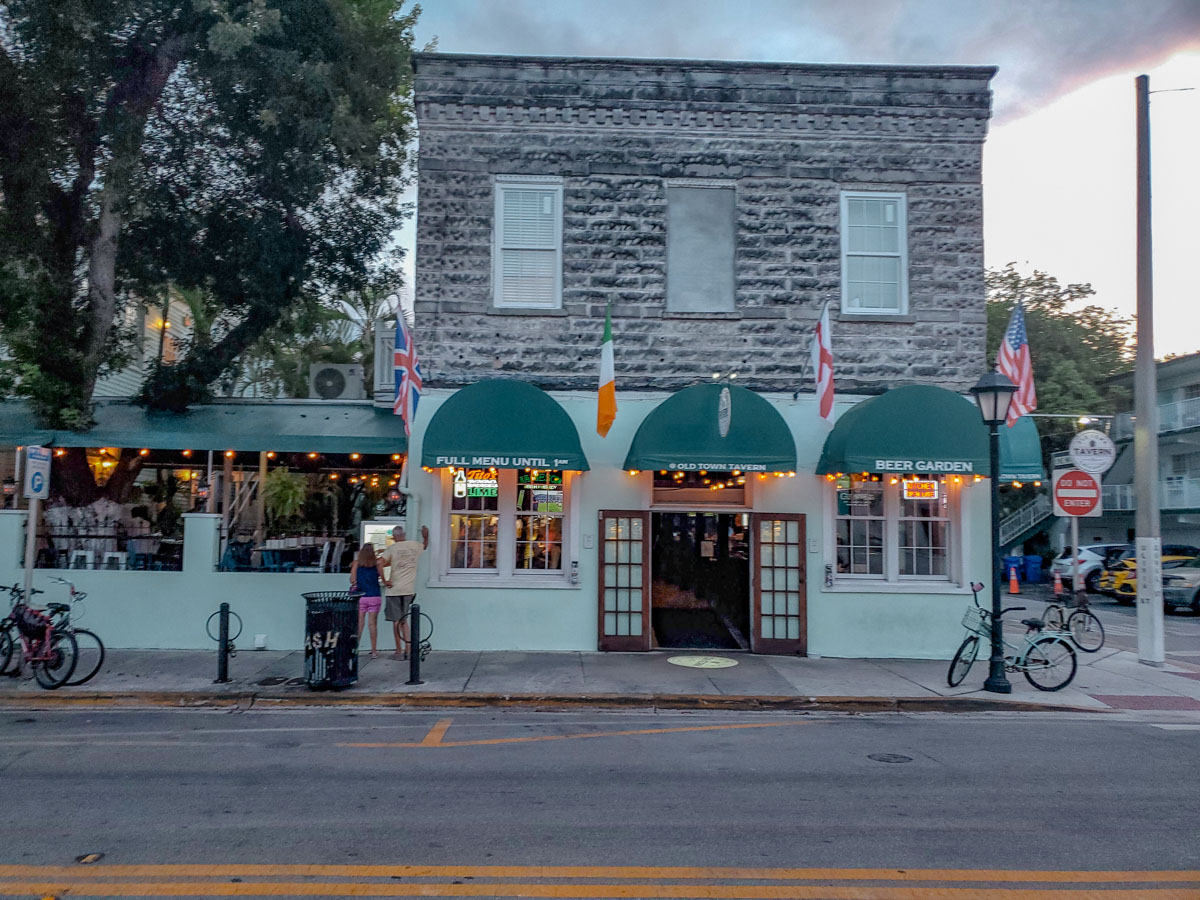 The front of a restaurant building with old building on the second floor, and a modern build on the first floor.