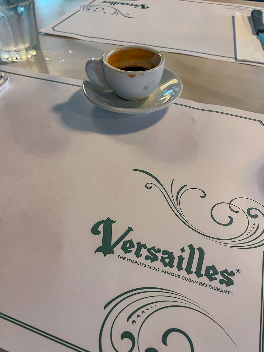 A cup of coffee over a paper placemat.