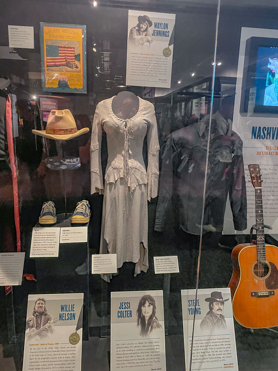 Clothes and instruments of legendary musicians being exhibited inside a museum in Nashville.