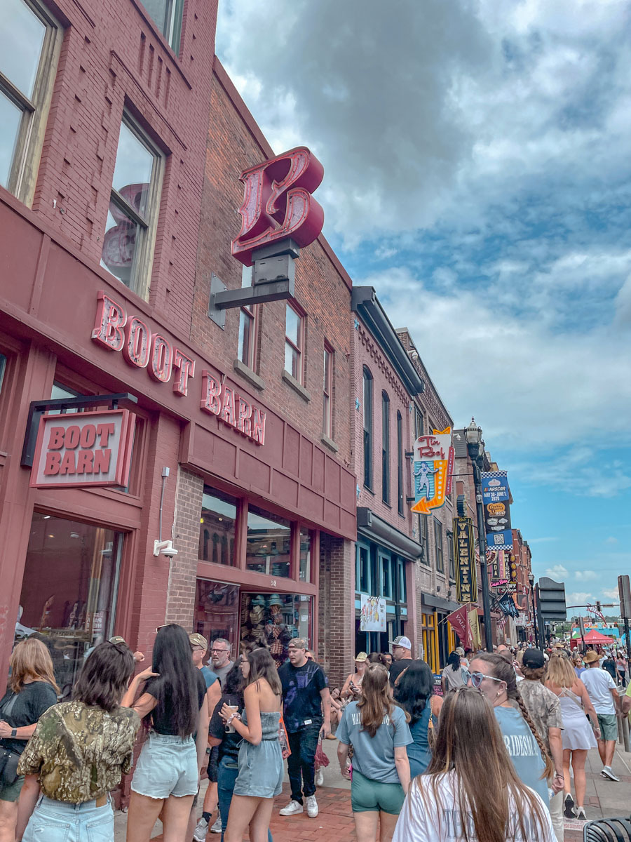 People walking on the sidewalk of Downtown Nashville.