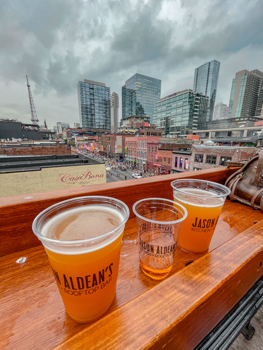 Three plastic cups of craft beer by the window in Nashville Tennessee.