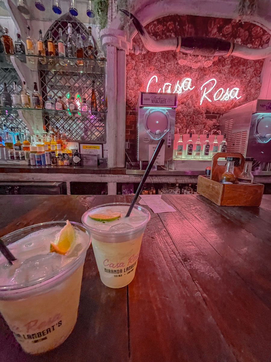 Two cups of drinks sitting on a wooden table inside Casa Rosa, one of the artist-owned venues in Nashville Tennessee.
