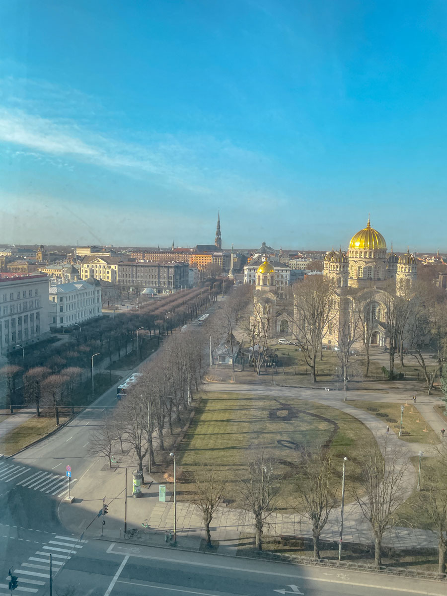 A view of a park and a church and old buildings in Riga from a hotel room window.