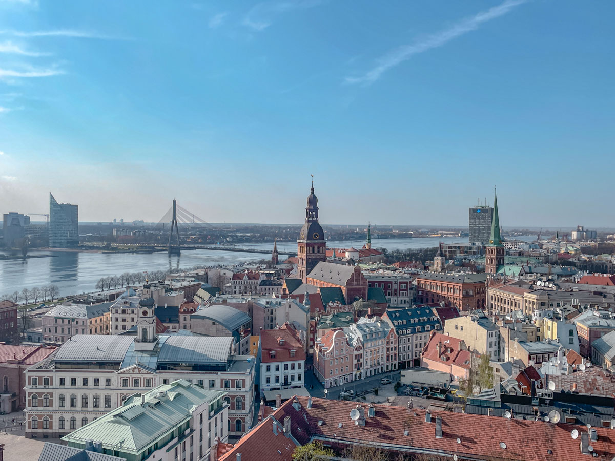 A view of Riga with buildings, river, and bridge.