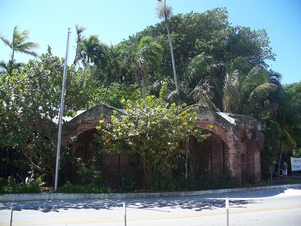 An old brick tower with many trees in Key West, Florida.