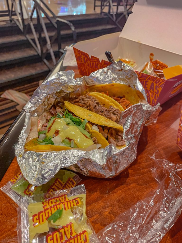 Takeout tacos on a tin foil container.