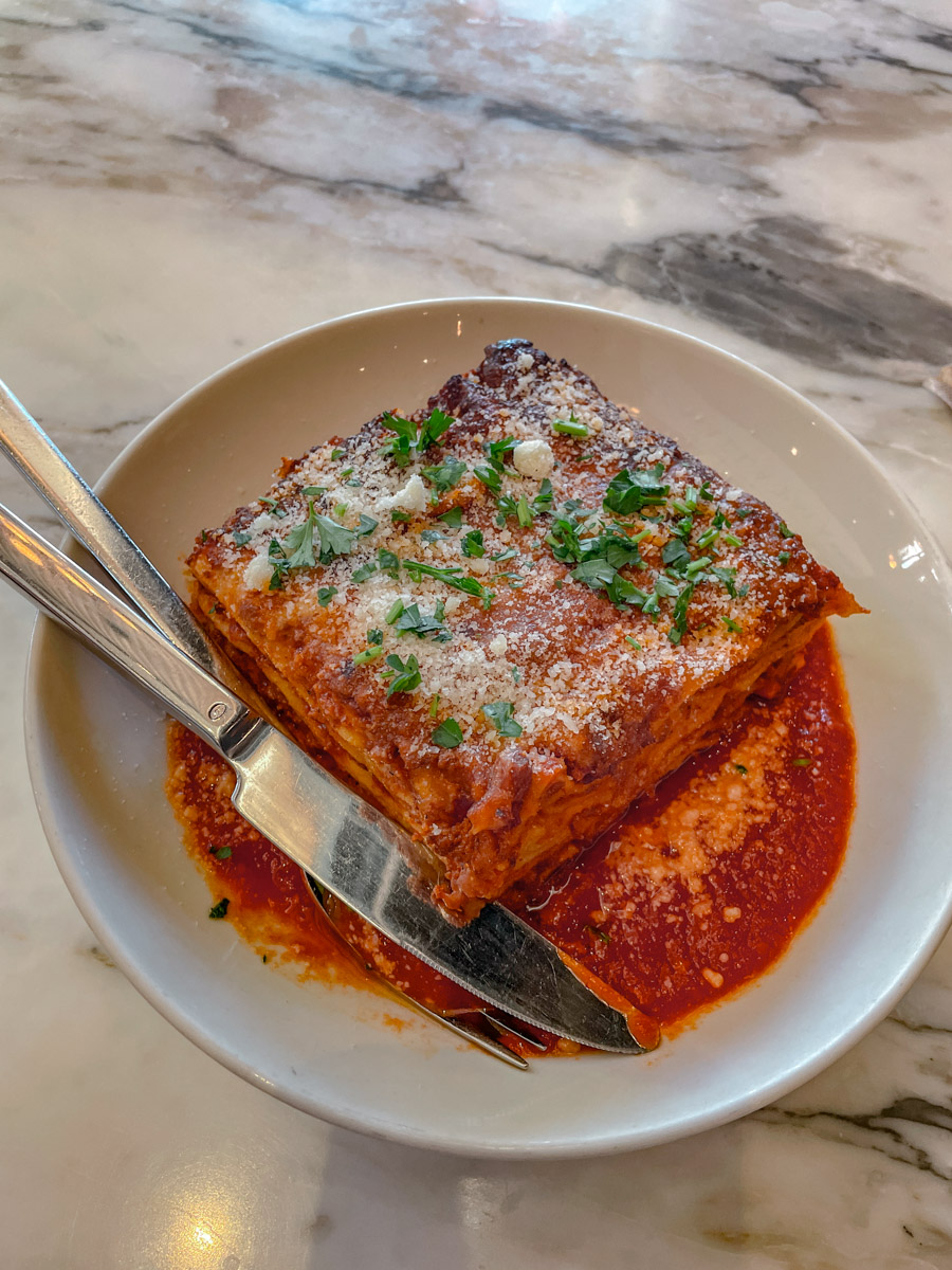 A serving of lasagna on a plate.