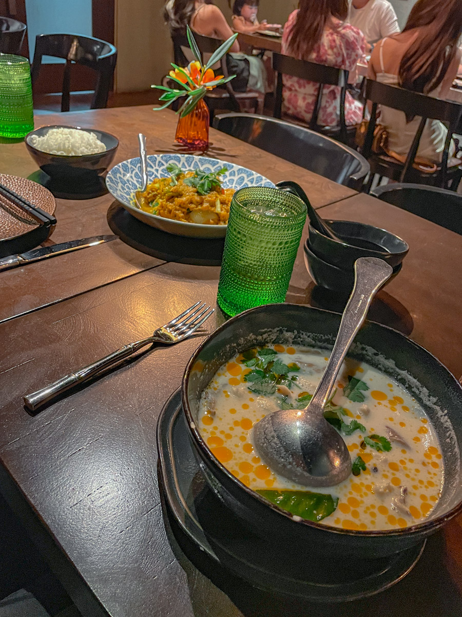 Bowls of food on a wooden table in a hotel restaurant.