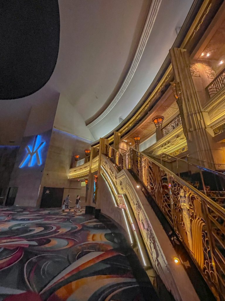 A carpeted area inside a hotel in Las Vegas with a grand staircase.