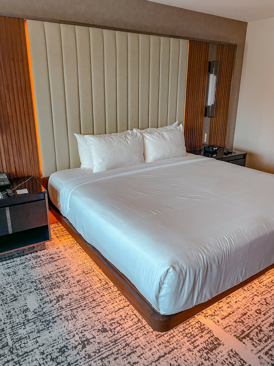 A big bed inside a hotel in Las Vegas with a carpeted floor.