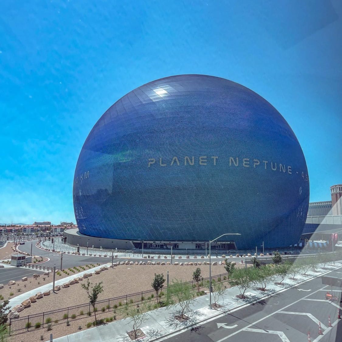 The outside of The Sphere arena in Las Vegas with the desert city in the background.