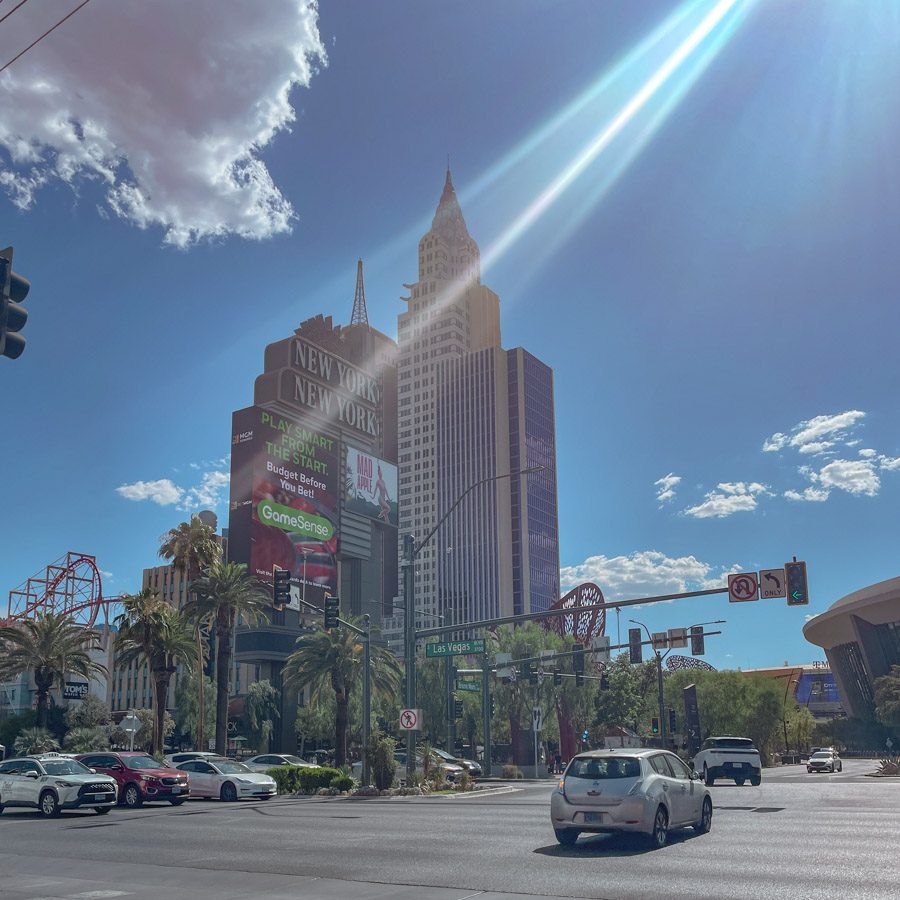 Sunny Las Vegas intersection with the New York-New York hotel building in the background.