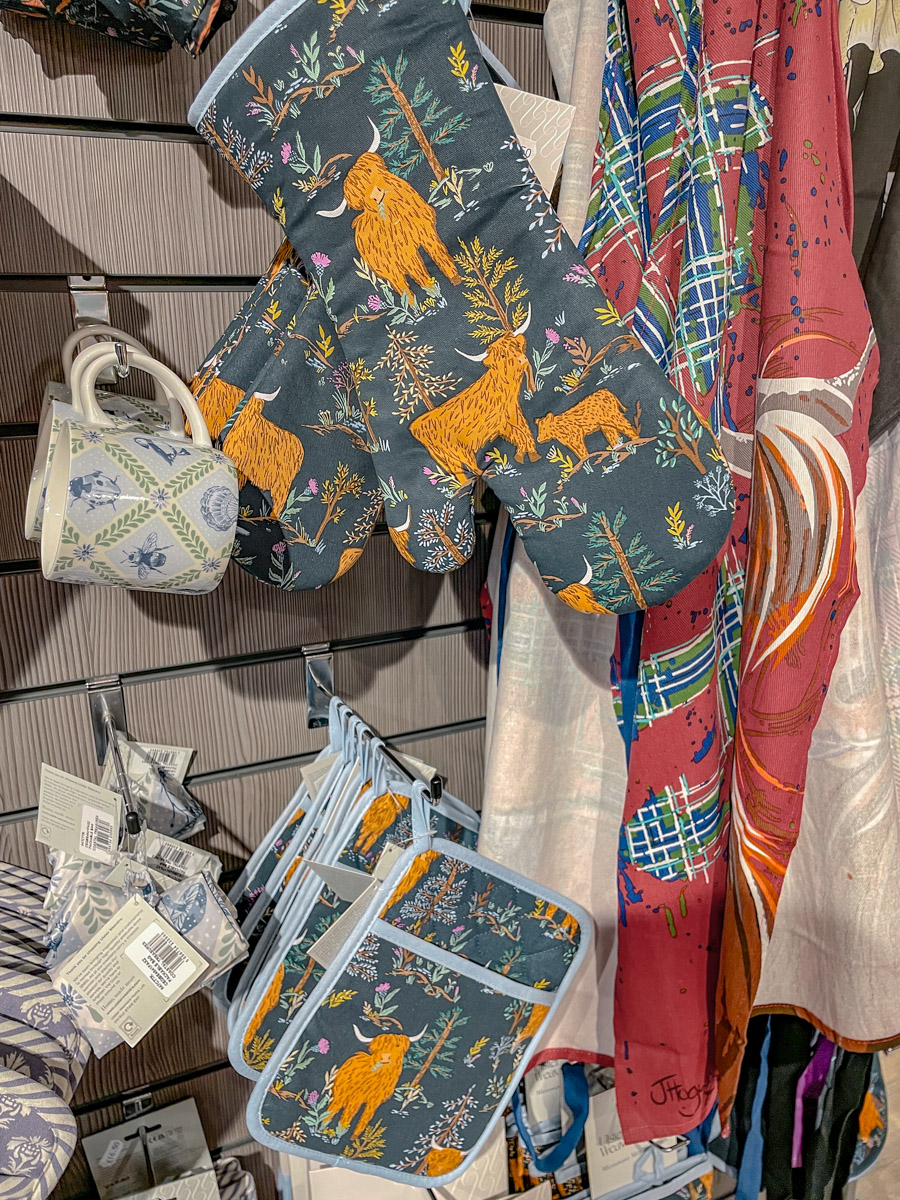 Mugs, gloves, and scarves on display.