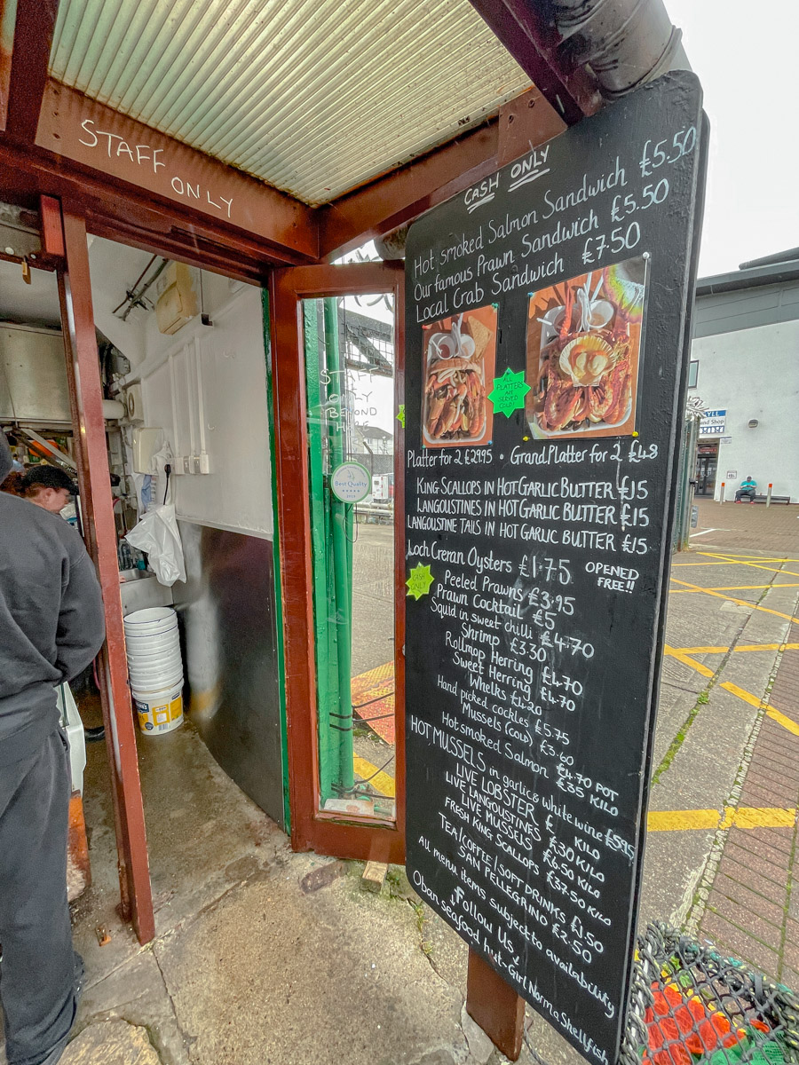 A blackboard chalk menu of a seafood stand in Oban, Scotland.