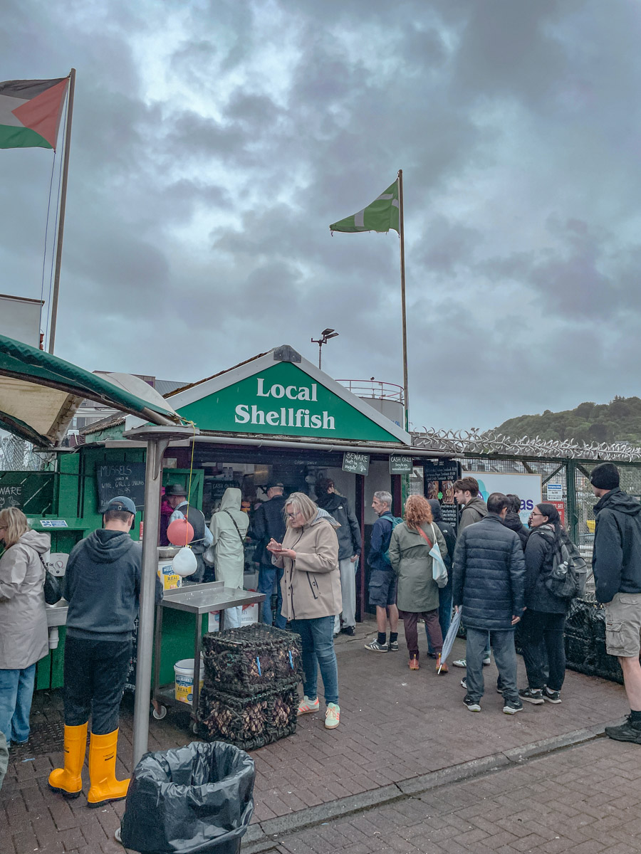 People lining up in front of a local shellfish stand in Oban, Scotland.