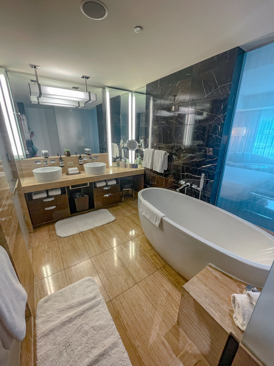 A hotel bathroom with a tub.