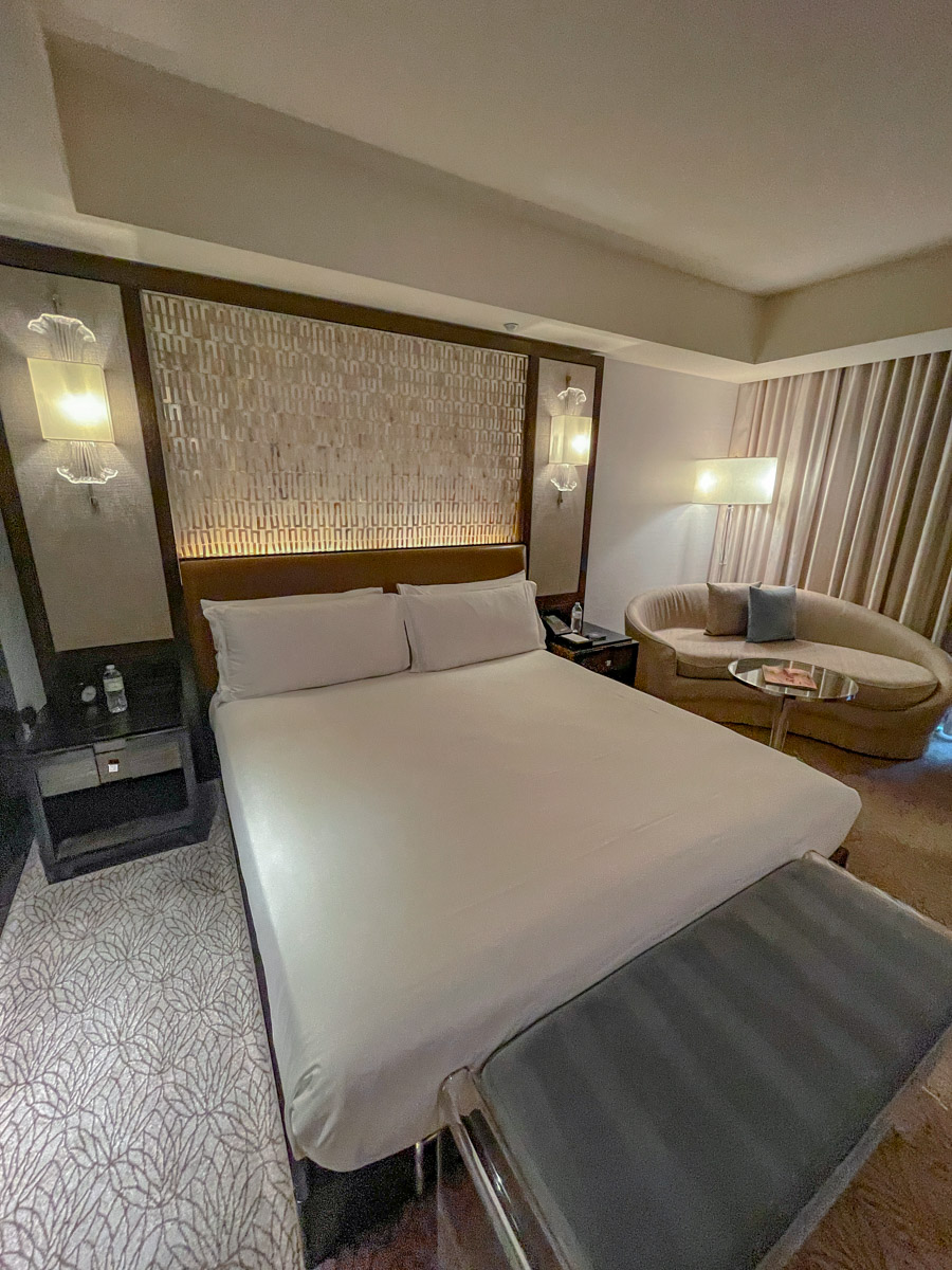 A king bed and a couch in a fancy hotel room in Las Vegas.
