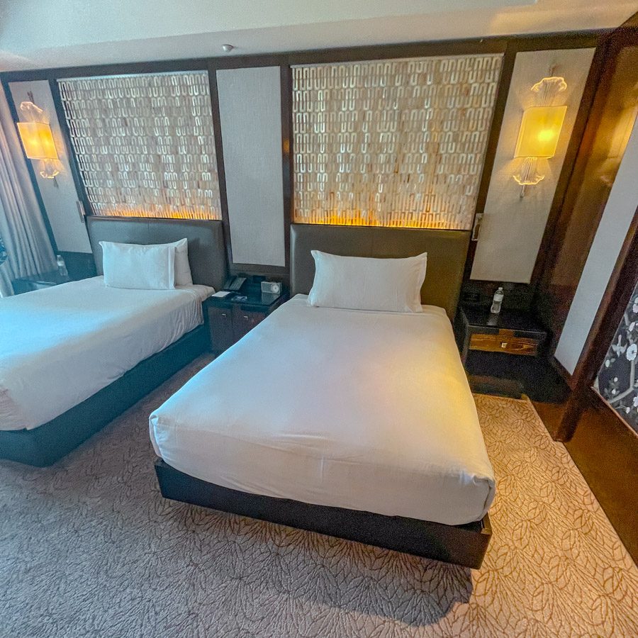 A hotel room with two beds.