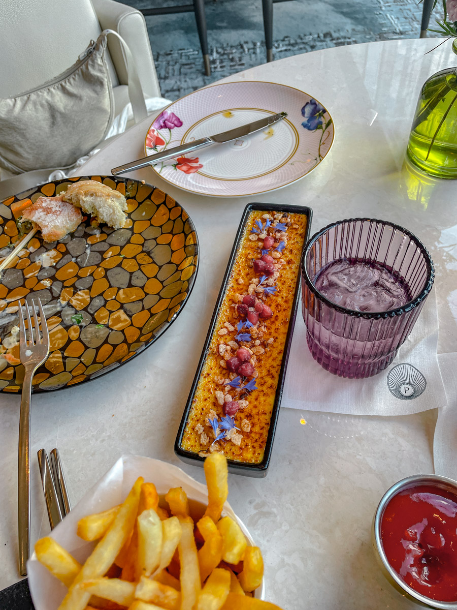 Cream brûlée with floral garnish.